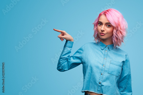 Bright stylish woman pointing away photo