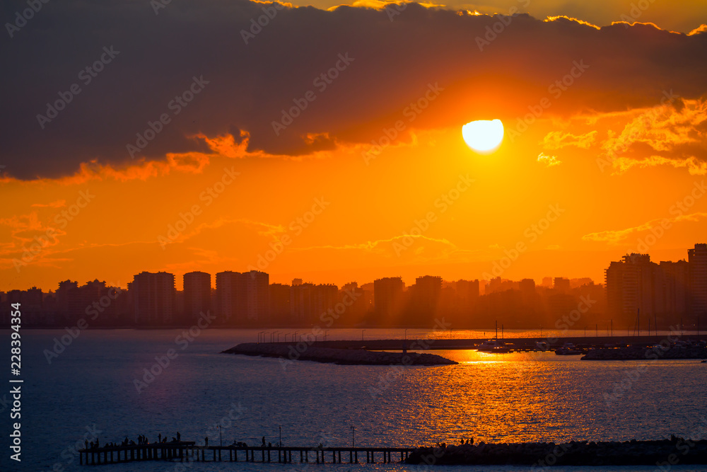 Mersin city coastline with Fishing Boats docked at Mersin Harbor at sunset