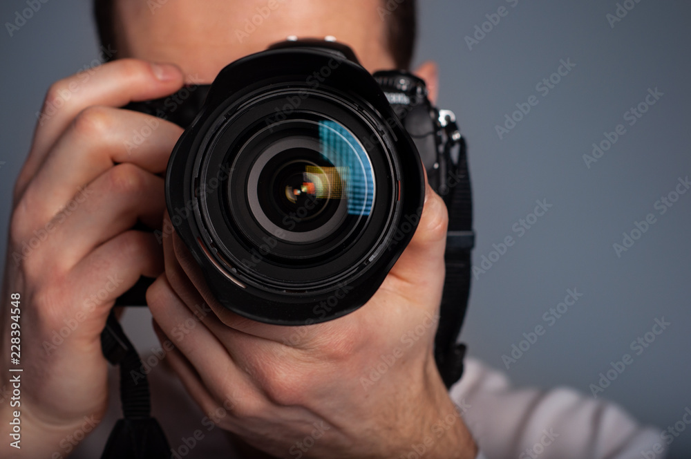Photographer using DSLR camera in studio Photographer using DSLR camera in studio