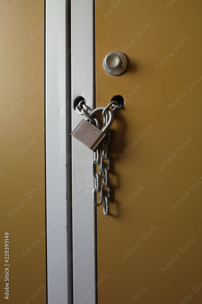 Old work cabinet with padlock and chain Old work cabinet with padlock and chain