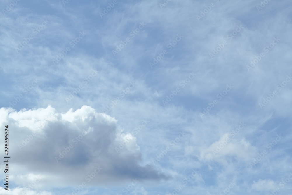 Blue sky filled with cirrus clouds and one cumulus cloud in the lower left. Blue sky filled with cirrus clouds and one cumulus cloud in the lower left.