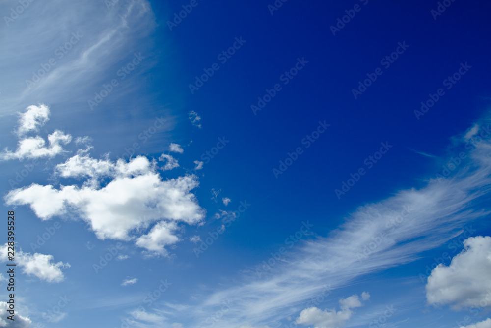 Blue sky with puffy cumulus and thin cirrus clouds. Blue sky with puffy cumulus and thin cirrus clouds.