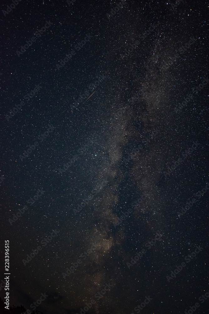 Clouds in the moonlight against the milky way summer night