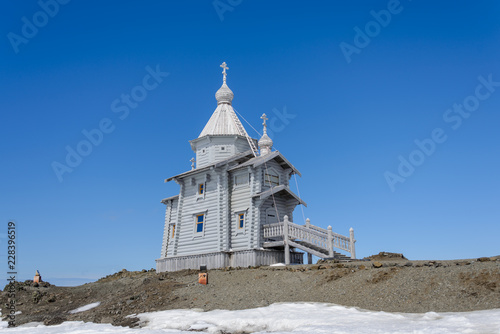 Wooden church in Antarctica on Bellingshausen Russian Antarctic research station and helicopter