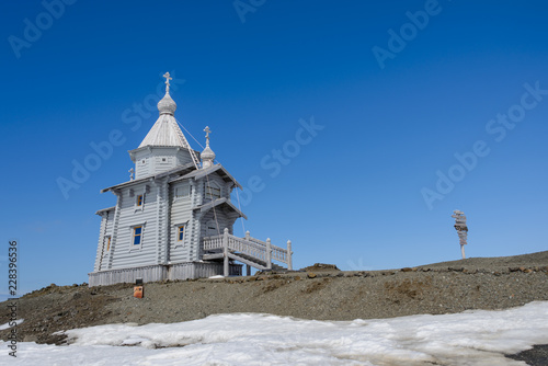 Wooden church in Antarctica on Bellingshausen Russian Antarctic research station and helicopter