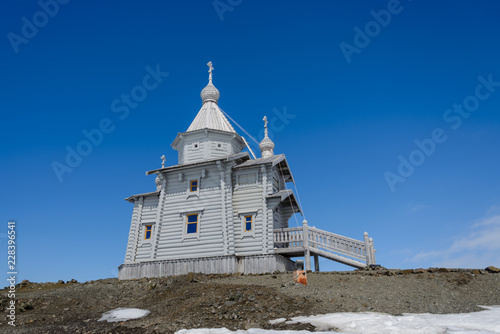 Fototapeta Naklejka Na Ścianę i Meble -  Wooden church in Antarctica on Bellingshausen Russian Antarctic research station and helicopter