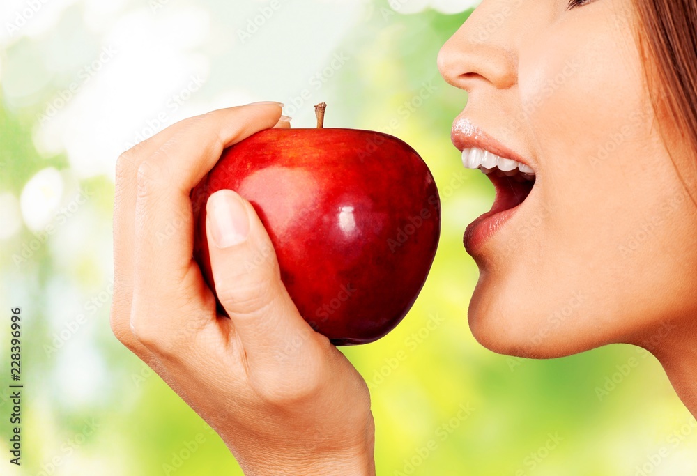 Young woman holding fresh apple Young woman holding fresh apple