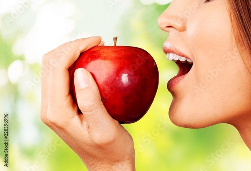 Young woman holding fresh apple