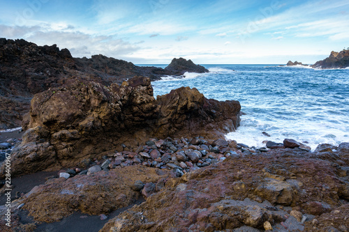 Seascape with waves crashing on the rocks in Seixal, Madeira © Luis