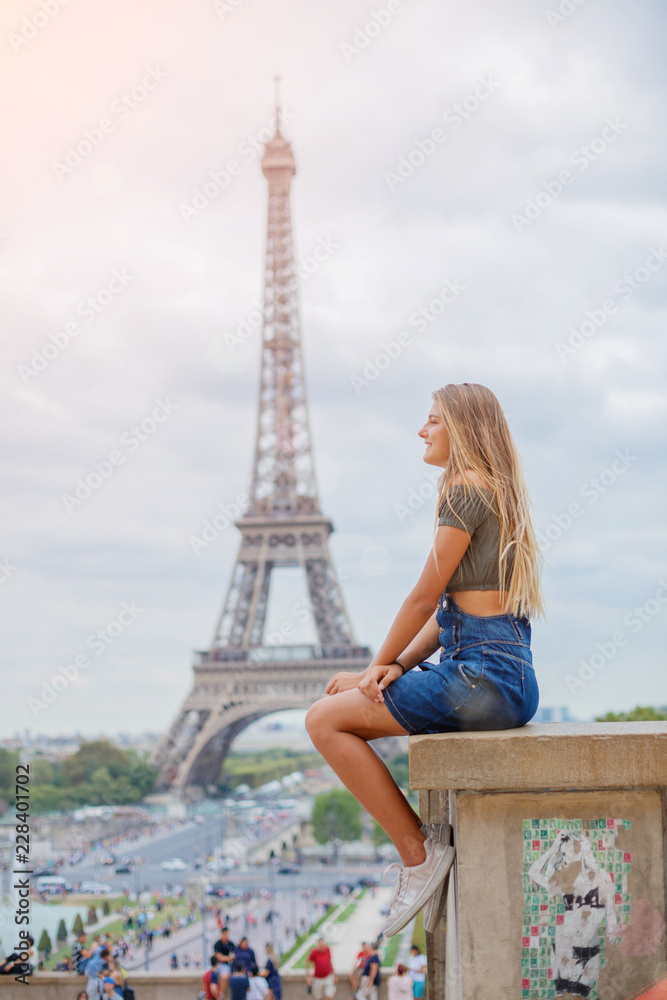 Girl sitting and watching down near the Eiffel tower