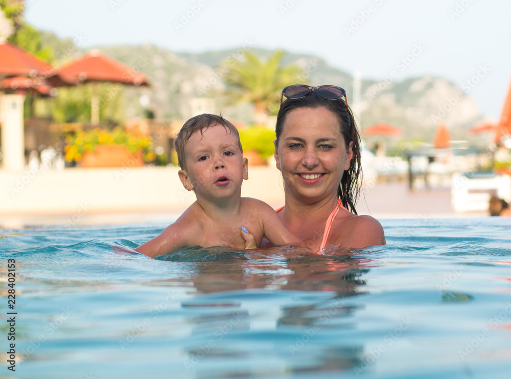 Mum with the child bathe in the pool Mum with the child bathe in the pool