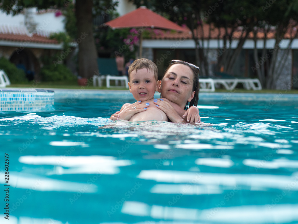 Mum with the child bathe in the pool Mum with the child bathe in the pool