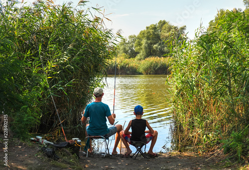 Dad And Son Fishing On the Lake.