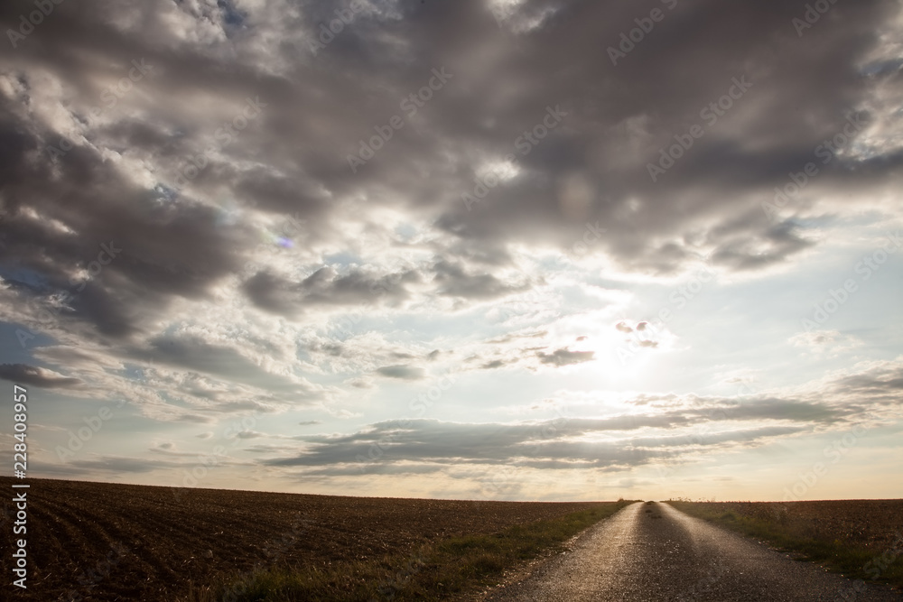 country road with surprisingly beautiful sky in france europe