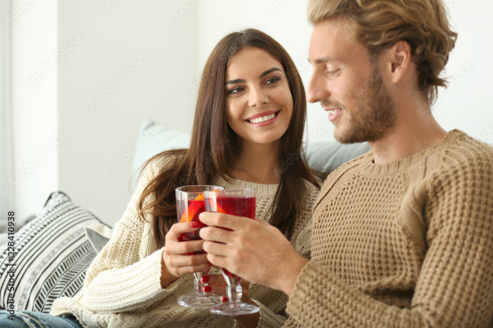 Couple drinking delicious mulled wine at home Couple drinking delicious mulled wine at home
