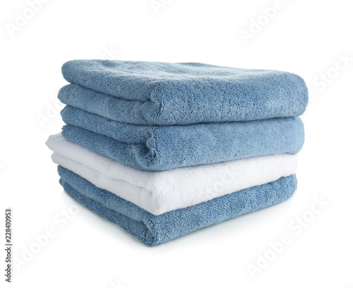 Stack of clean soft towels on white background