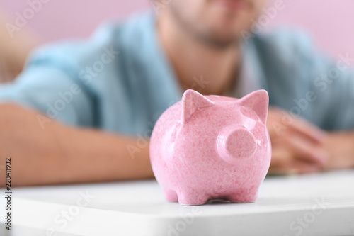 Cute piggy bank on table