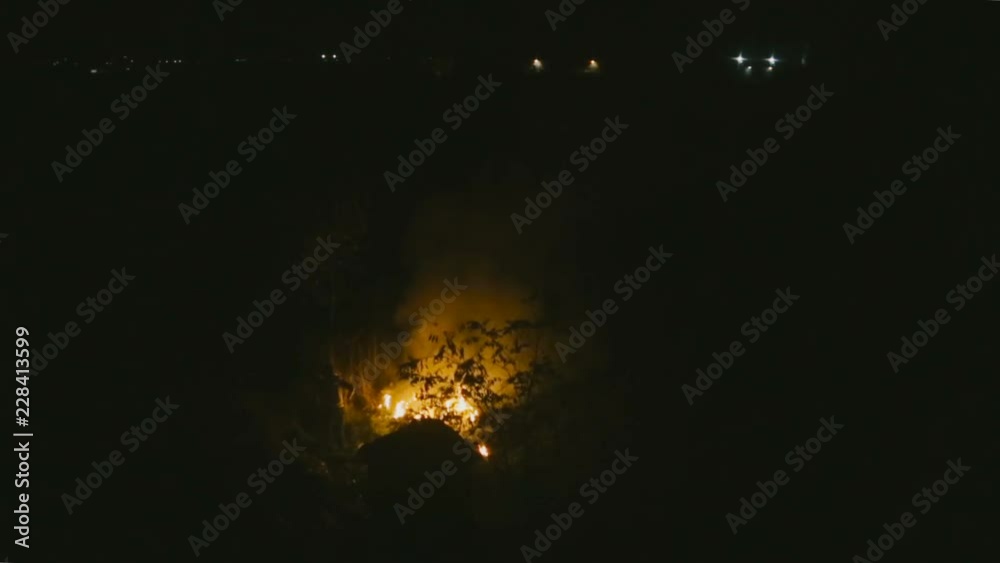 Homeless people near a fire on the field at night - LS Homeless people near a fire on the field at night - LS