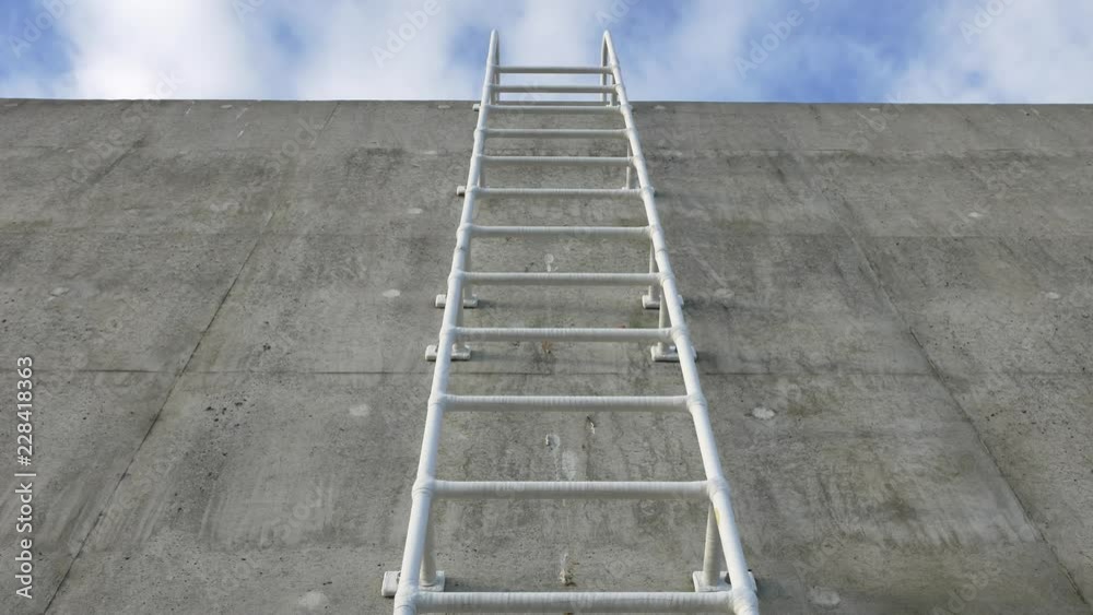 Concrete wall and white ladder Concrete wall and white ladder