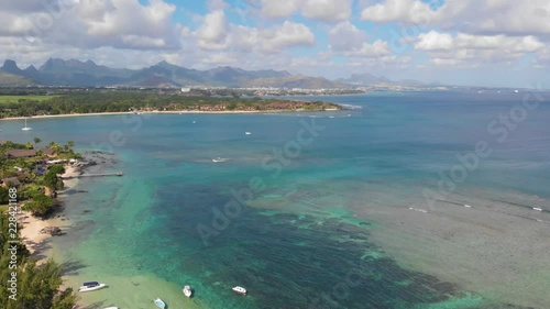 Aerial 4K Wide shot of Beach with clear torquise water with mountains in the background in troipical paradise in Balaclava Mauritius photo