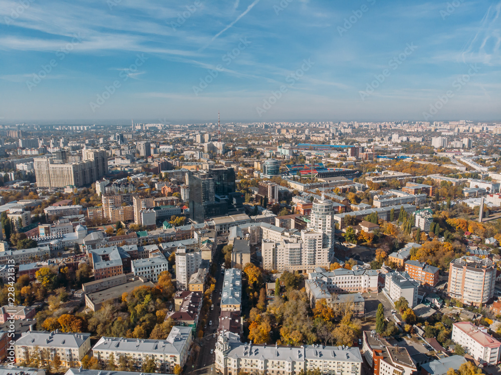 Fototapeta premium Aerial drone shot of Voronezh downtown with buildings from above, parks, streets with cars in sunny autumn day