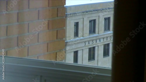 A cinematic shot looking through a window at a building with 