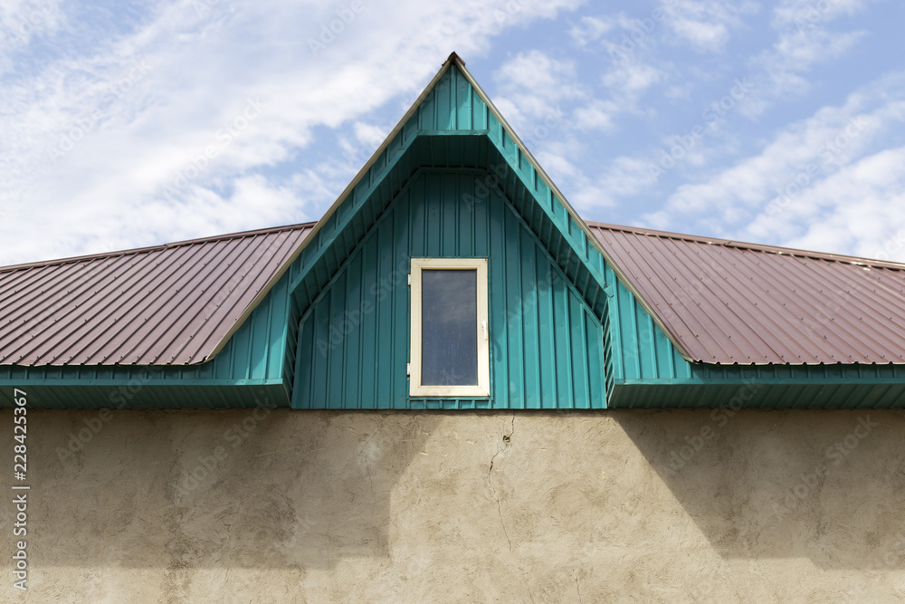 Roof of a house on a blue sky background