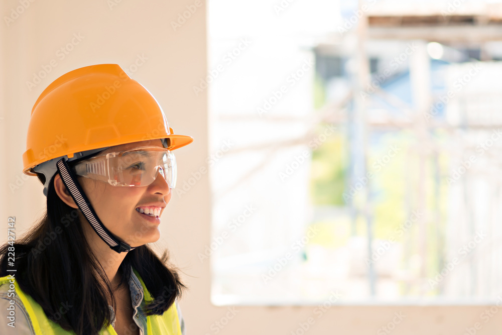 Women Engineering wearing yellow helmet and working at construction site Women Engineering wearing yellow helmet and working at construction site