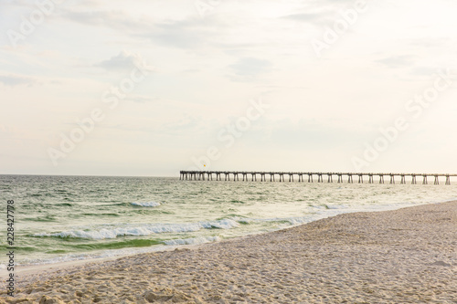 Beach scene  with pier in distance