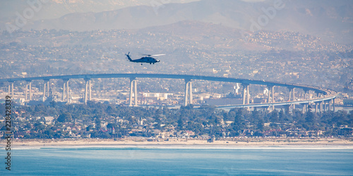 Chopper in San Diego sky over Coronado Bridge