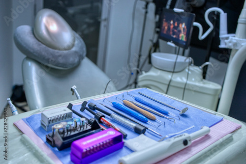 Selective focus of necessary dental equipment and working tool for dentist background chair and defocused medical office. cold and blue tones