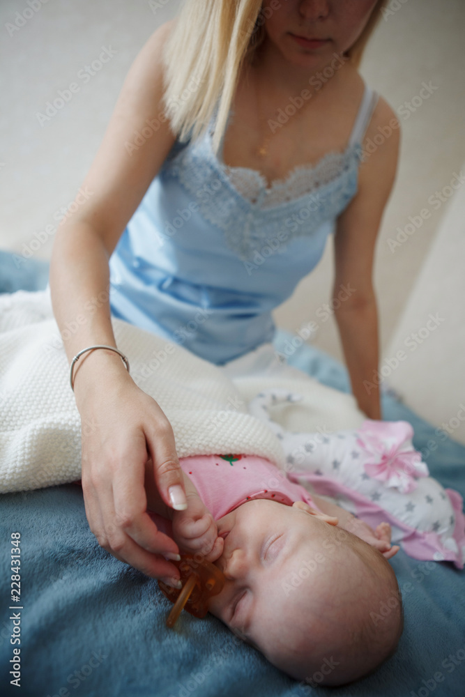 Mother giving a pacifier to her baby Mother giving a pacifier to her baby