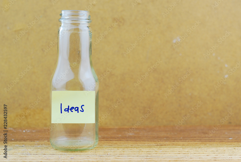 Empty glass jar and sticky note with text ideas