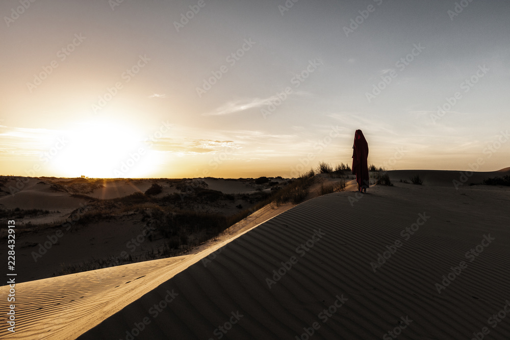 Man with a robe stares into the sun