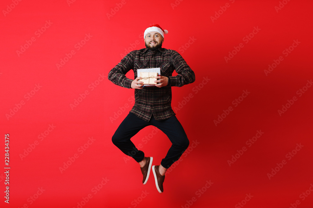 Man jumping with Christmas gifts