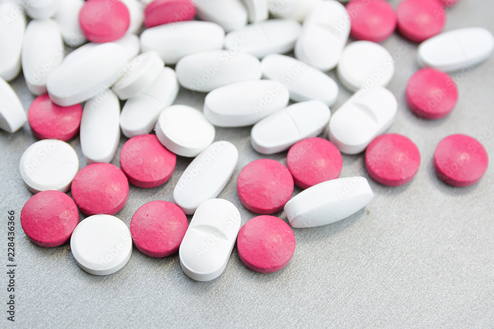 A bunch of colorful pills on a gray background.Medical topic A bunch of colorful pills on a gray background.Medical topic