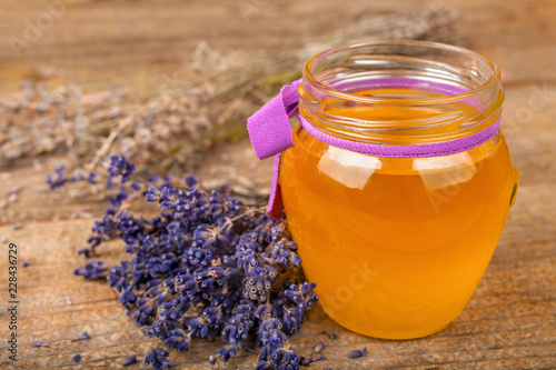 Honey from lavender with a lavender flower on a rustic background