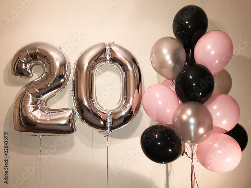 Composition of helium balloons white, pink, transparent with confetti, as well as a gold star and a large figure of twenty silver colors. Gift for 20 years for a girl