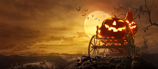 Halloween pumpkins on farm wagon going through Stretched road grave to Castle spooky in night of full moon and bats flying