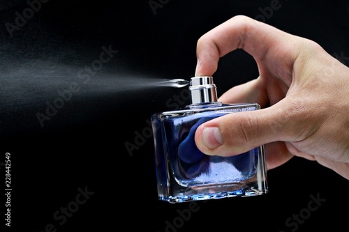 Konstfotografi Cologne or perfume bottle being sprayed- isolated image