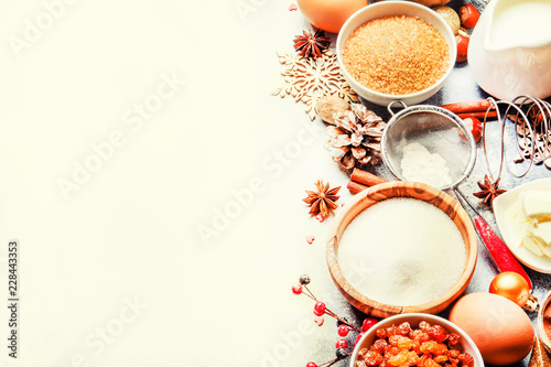 Christmas or New Year composition with ingredients for baking festive cookies, with golden snowflakes, Christmas balls, pine cones on white background, top view
