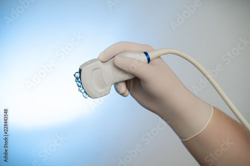 Fotografía Ultrasound probe in hand with gel backlit