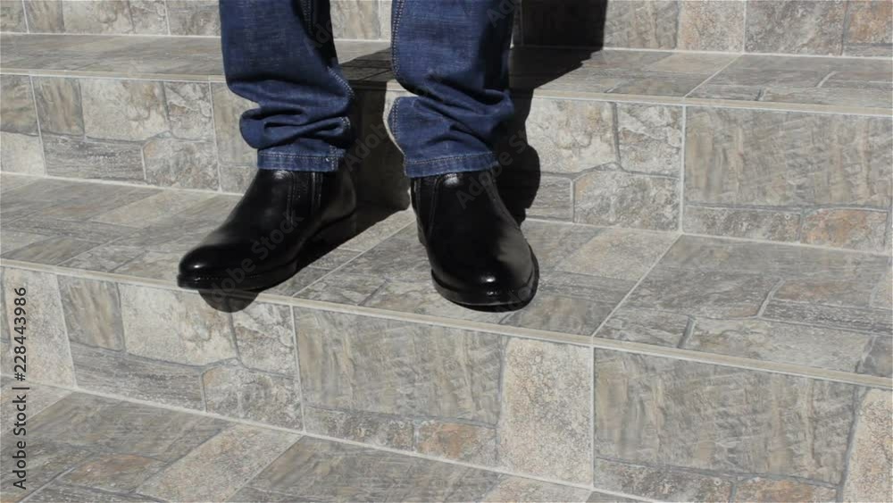 stand on the stairs of a man,standing on the stairs of stones in black shoes businessman