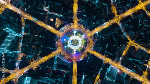 Aerial view highway road 6 way intersection roundabout or circle at dusk for transportation, distribution or traffic background. © Pawinee