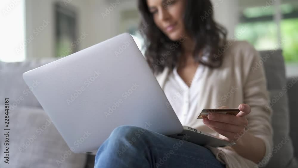 Brunette woman shopping online at home