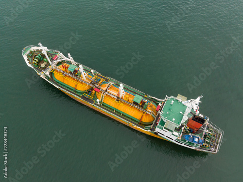 Aerial Top View of sea freight, Crude oil tanker lpg ngv at industrial estate Thailand / Crude Oil tanker to Port of Singapore - import export around in the world © AUUSanAKUL+