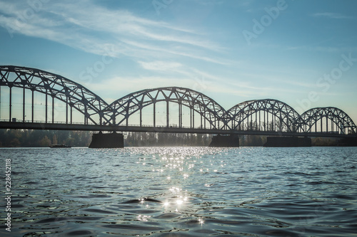 Railway bridge in Riga over the Daugava River in the fall in October on a sunny day © jteivans