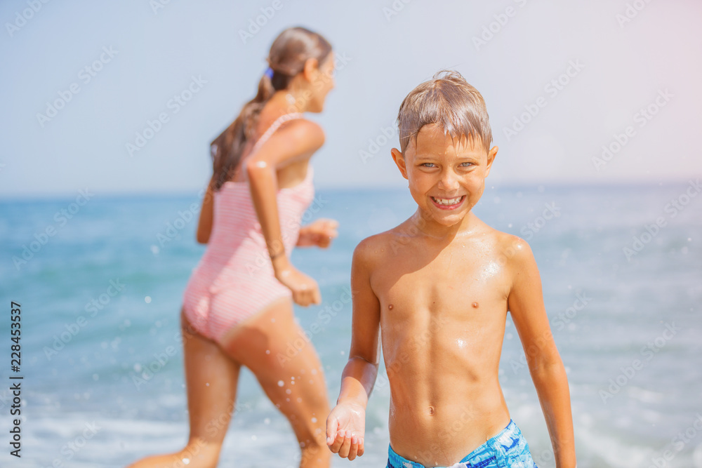 Two happy kids having fun on the beach Two happy kids having fun on the beach