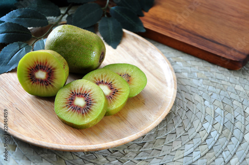 Fresh Red Kiwifruit on Wooden Plate