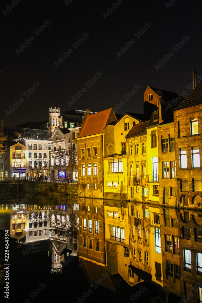 Night view of the old town and reflection in the river in the city of Ghent Belgium